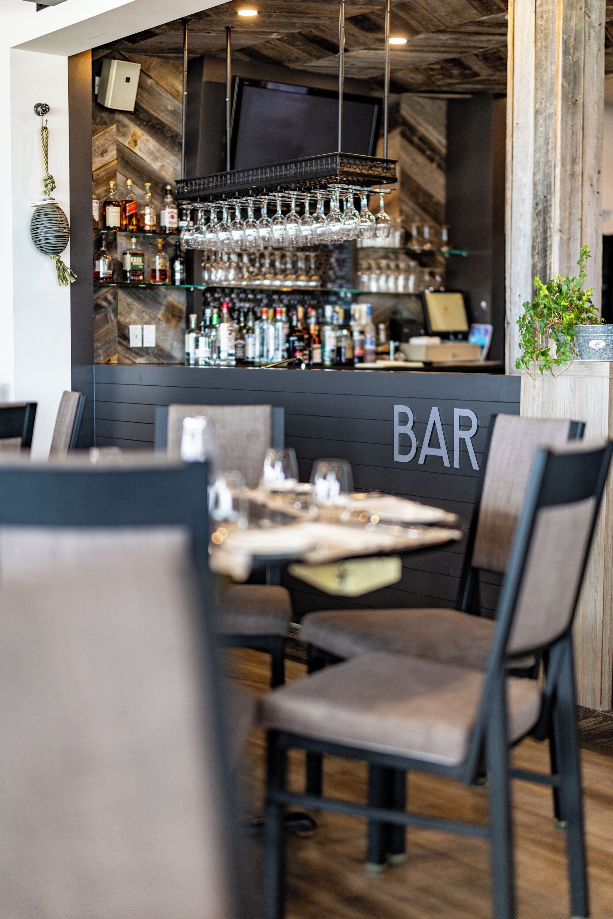 A bar area with a wooden interior, bar counter, and seating arrangement.