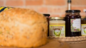 A basket containing jars of Worcestershire honey and a loaf of bread. - Huntlands Farm (Worcester)