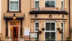 A two-story building with a sign reading "Courtyard."