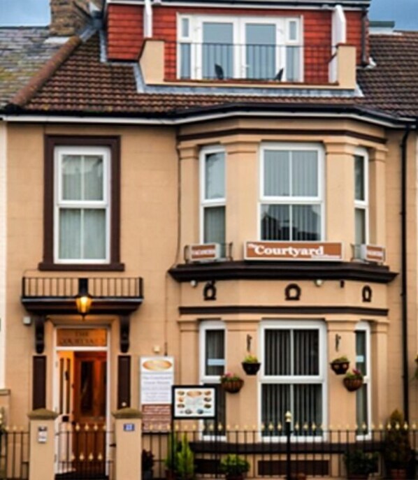 A two-story building with a sign reading "Courtyard." - The Courtyard Guest House (Great Yarmouth)
