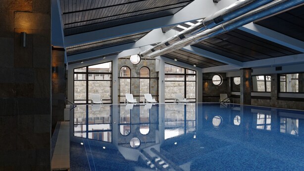 An indoor swimming pool with clear glass walls, stone walls, and a modern ceiling design. - Trinity Residence Bansko (Bansko)