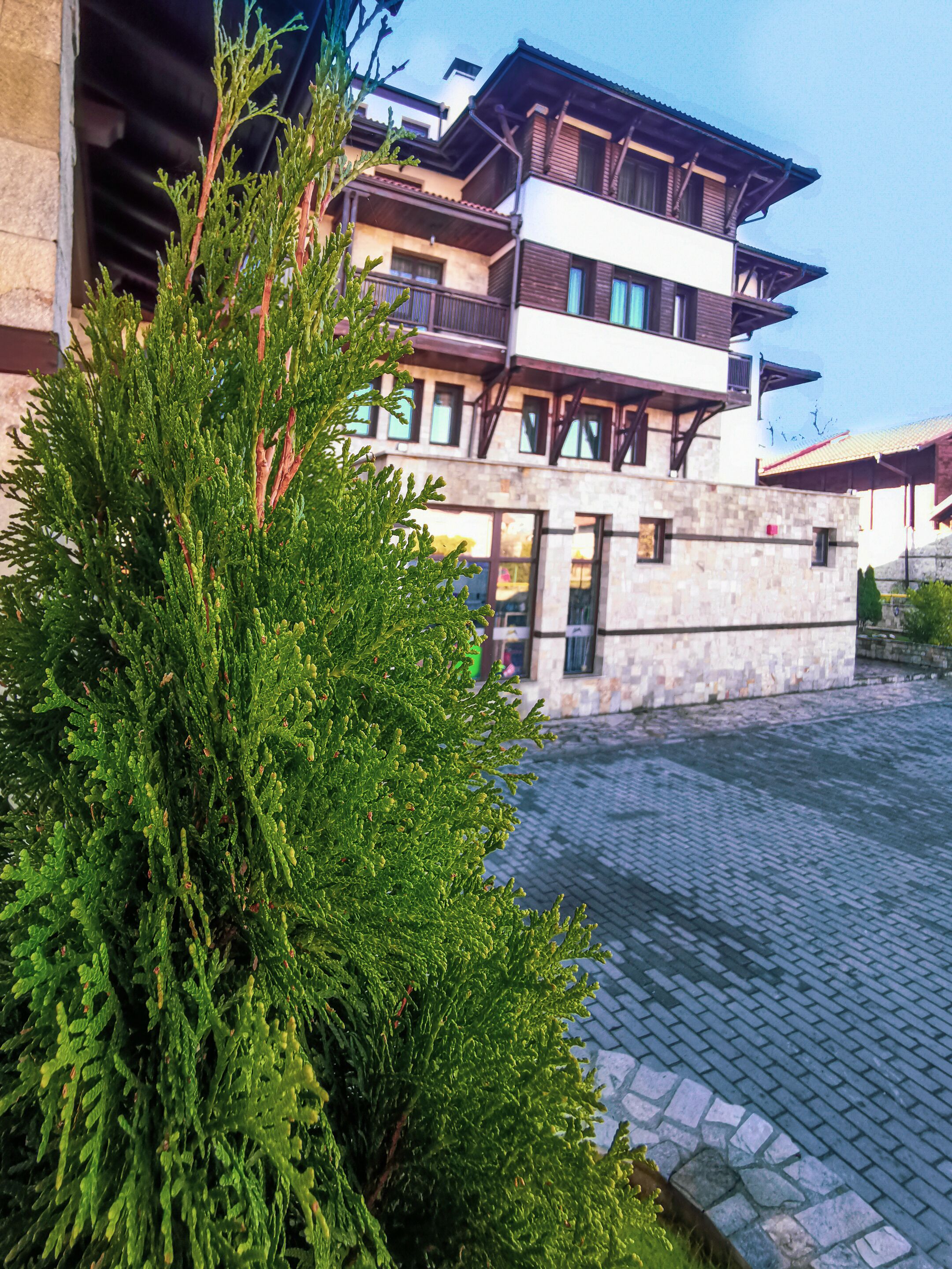 A multi-story building with a stone facade and wooden balconies.