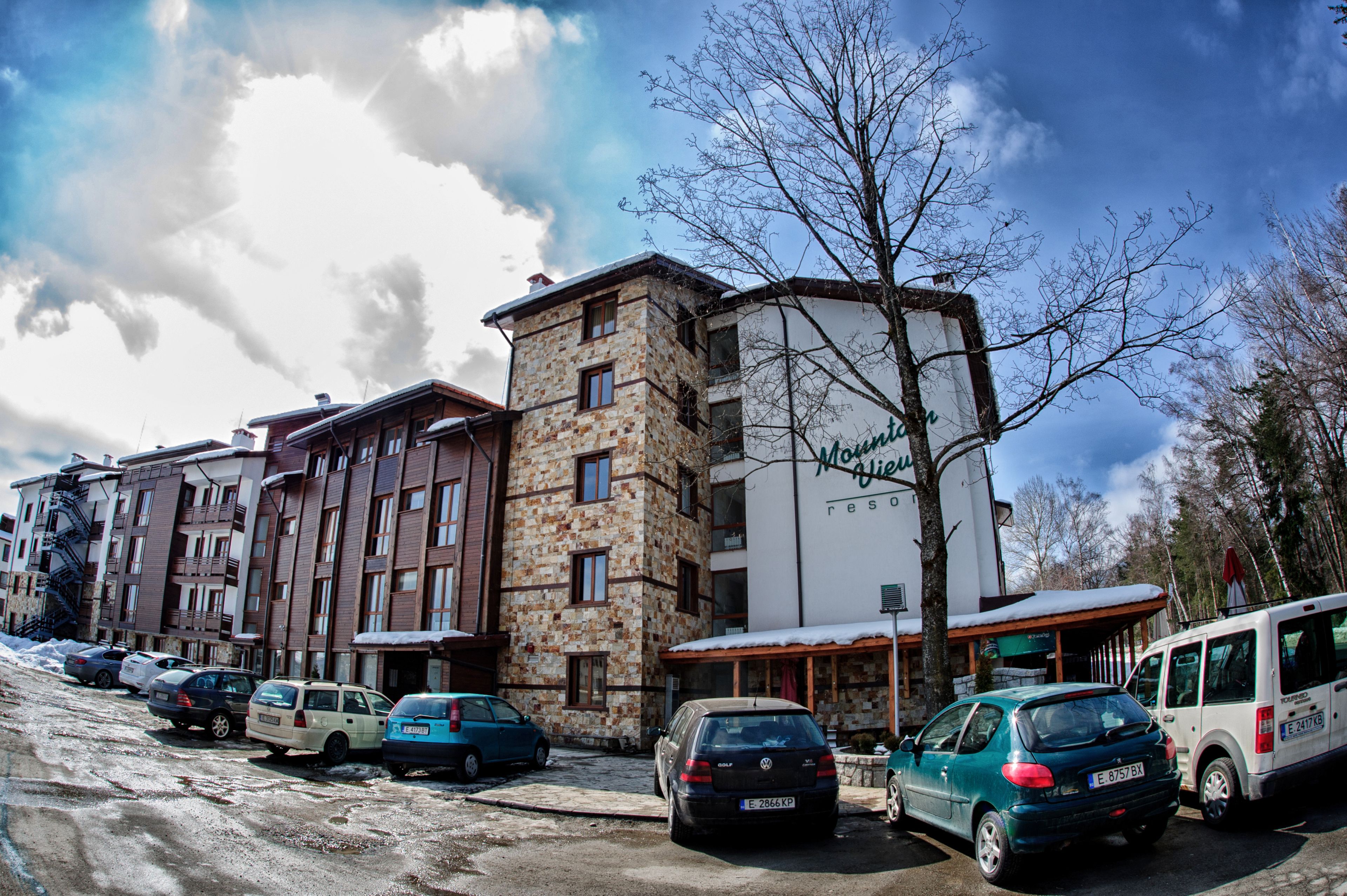 A multi-story building with a stone facade and a sign that reads "Moguls Hotel."