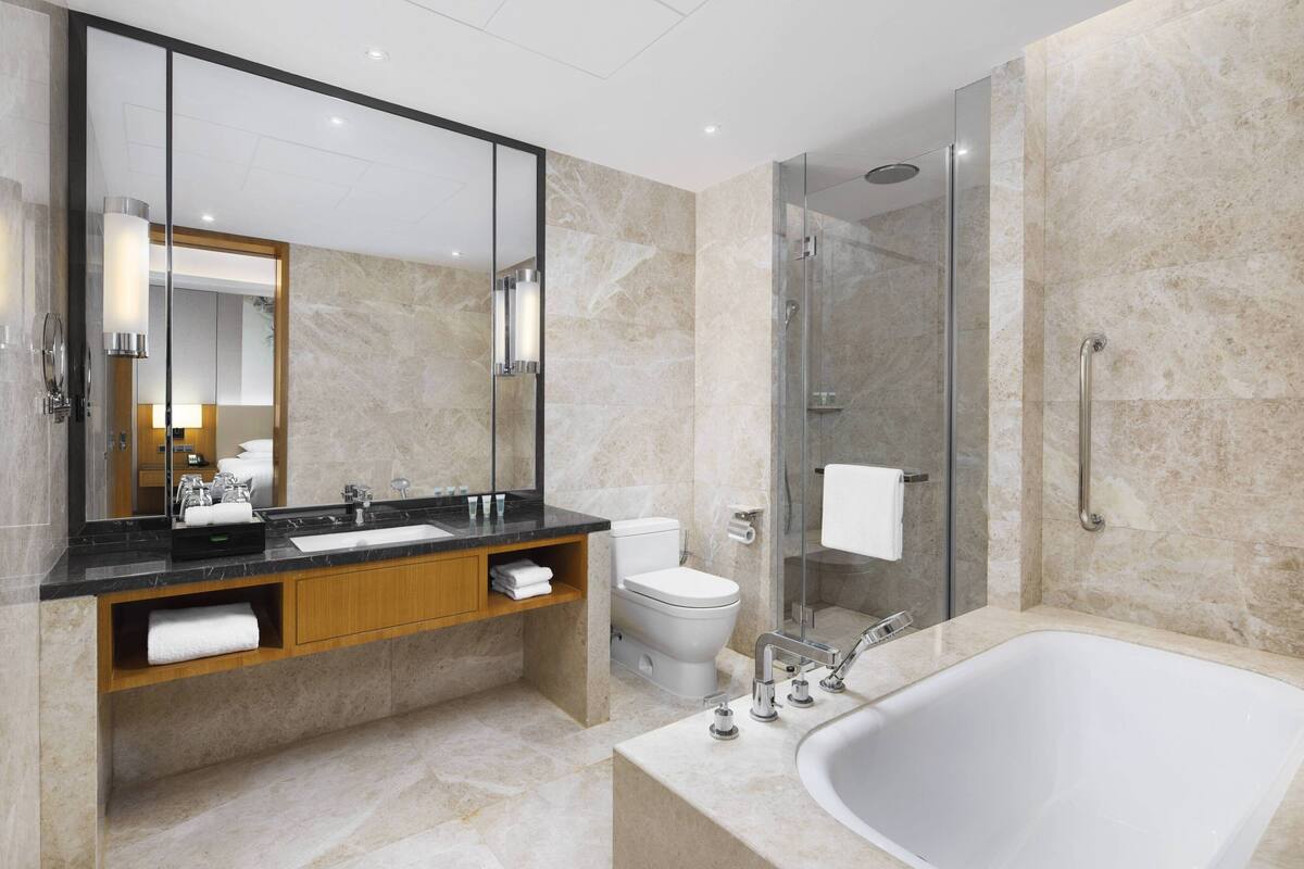 shower, hair dryer, slippers, towels