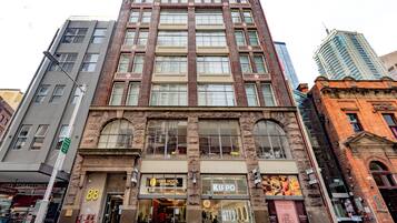 A multi-story building with a ground-floor shop named 'KIRPO'.