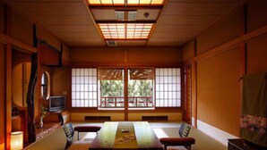 A traditional Japanese room with tatami flooring, a low table, and shoji screens. - Chikurakan (Minamiboso)