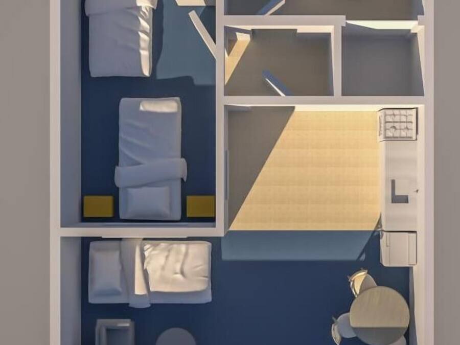 A hotel room layout with a bed, a desk, a chair, a small table, and a bathroom.