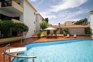 Seasonal outdoor pool, open 10 AM to 7:00 PM, pool umbrellas