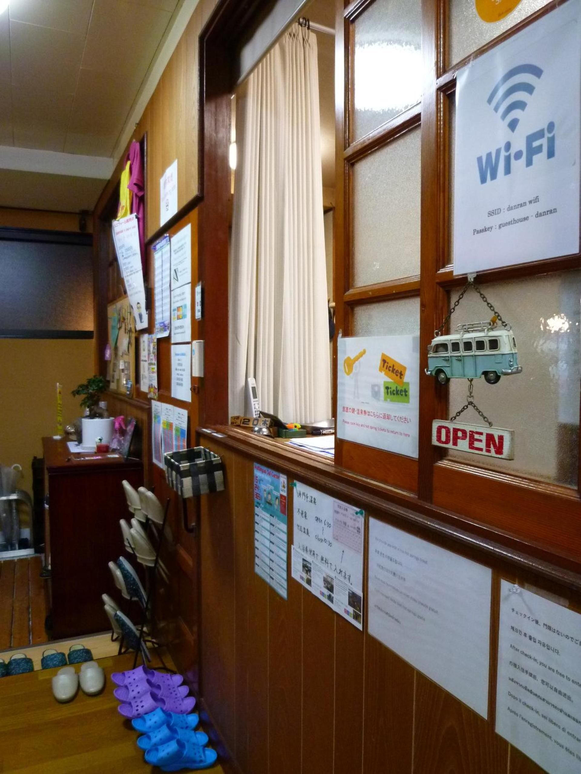 A reception area with a wooden desk, a ticket counter, and various informational posters.