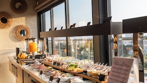 A buffet with various food items and a menu sign. - Rise Urban Art Hotel (Larnaca)