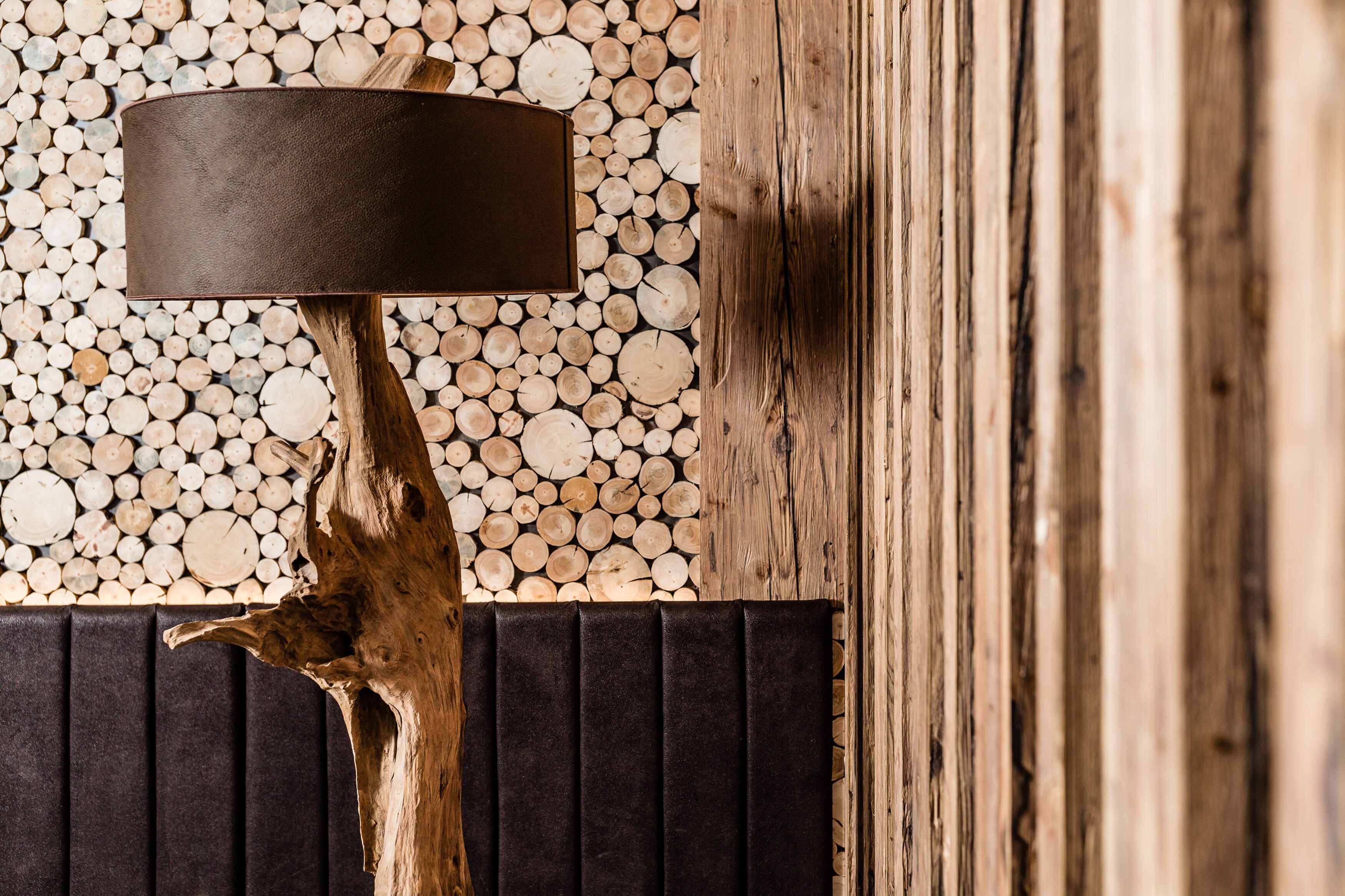 A wooden wall with a textured pattern and a black panel.