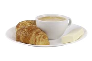 A croissant, a cup of coffee, and a piece of cheese on a white plate. - Hotel Metro 26 (Bogotá)