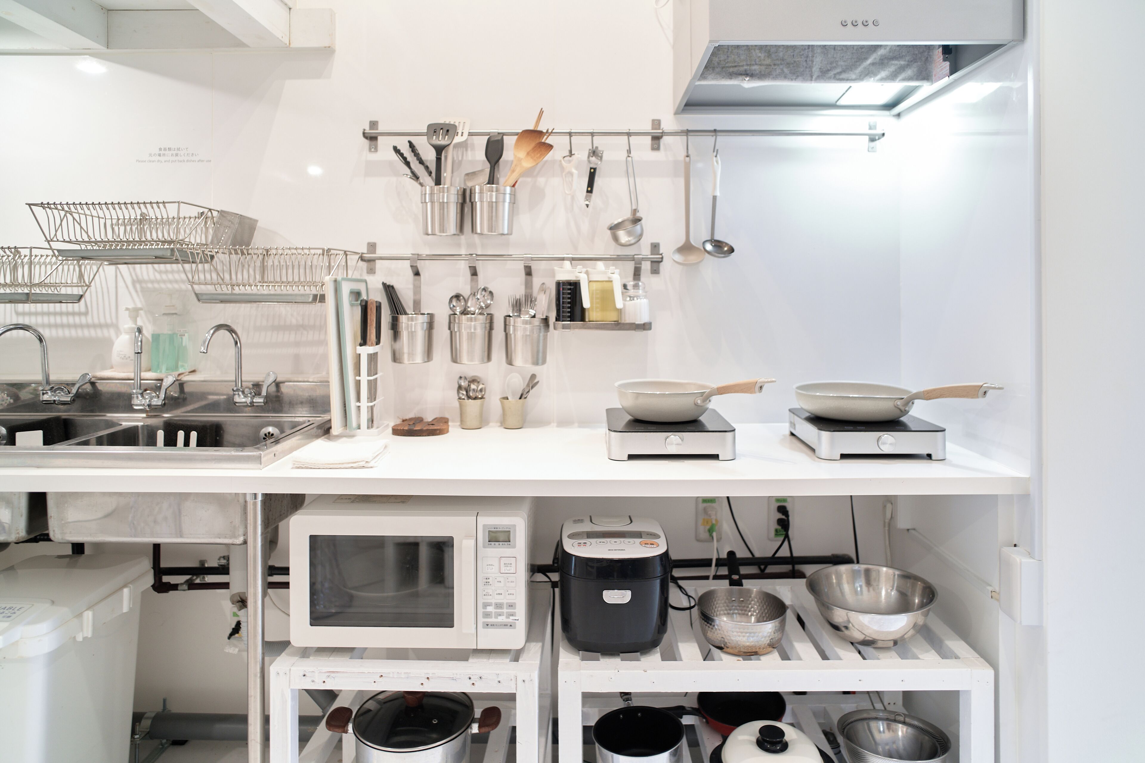 A kitchen with stainless steel appliances, including a microwave, stove, and sink.