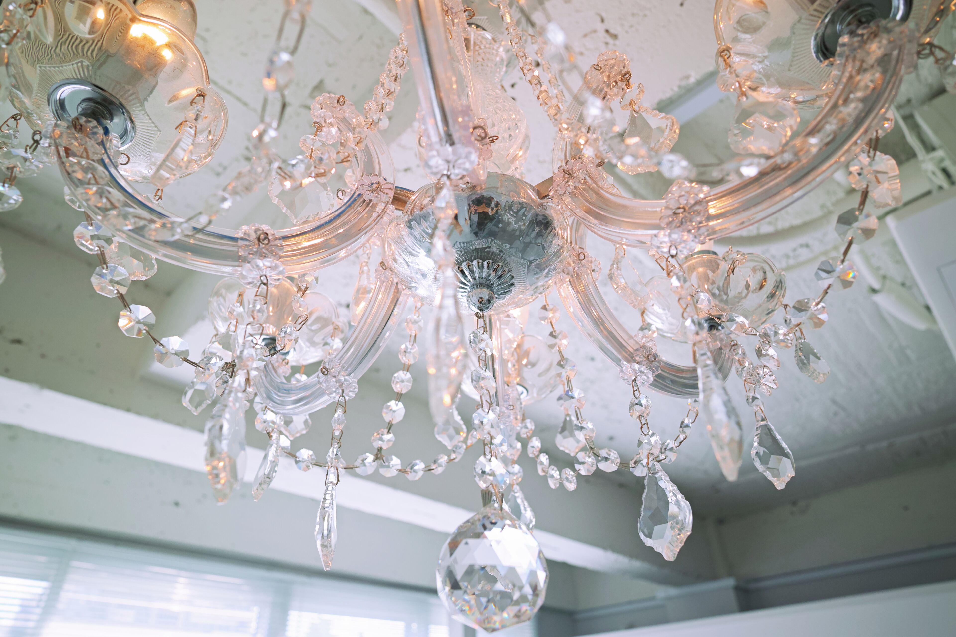 A chandelier with multiple arms and crystal decorations.