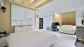 Premium bedding, desk, laptop workspace, blackout drapes