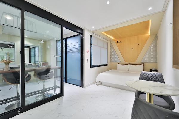 Premium bedding, desk, laptop workspace, blackout drapes