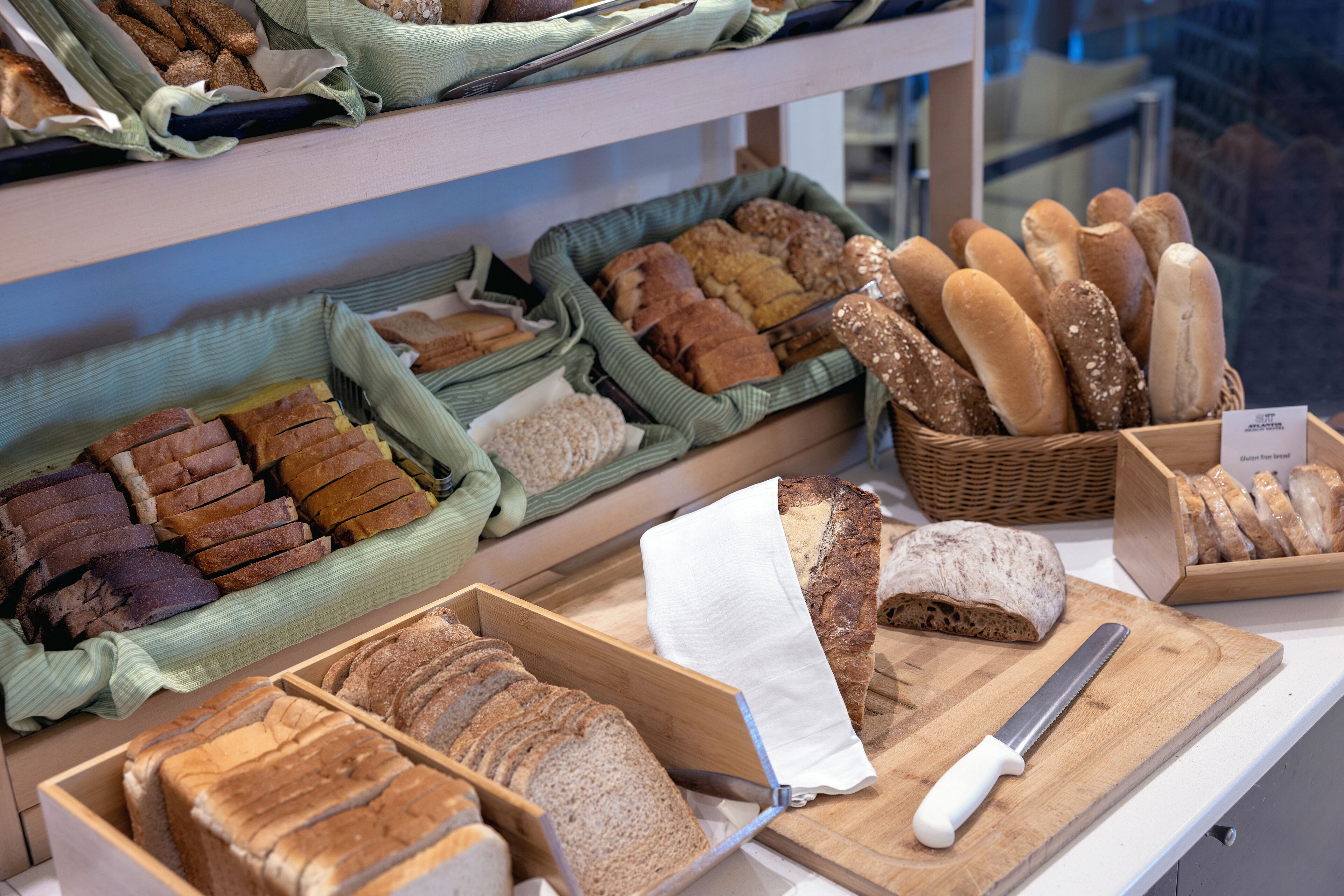 Una vitrina de panadería con distintos tipos de pan y pasteles.
