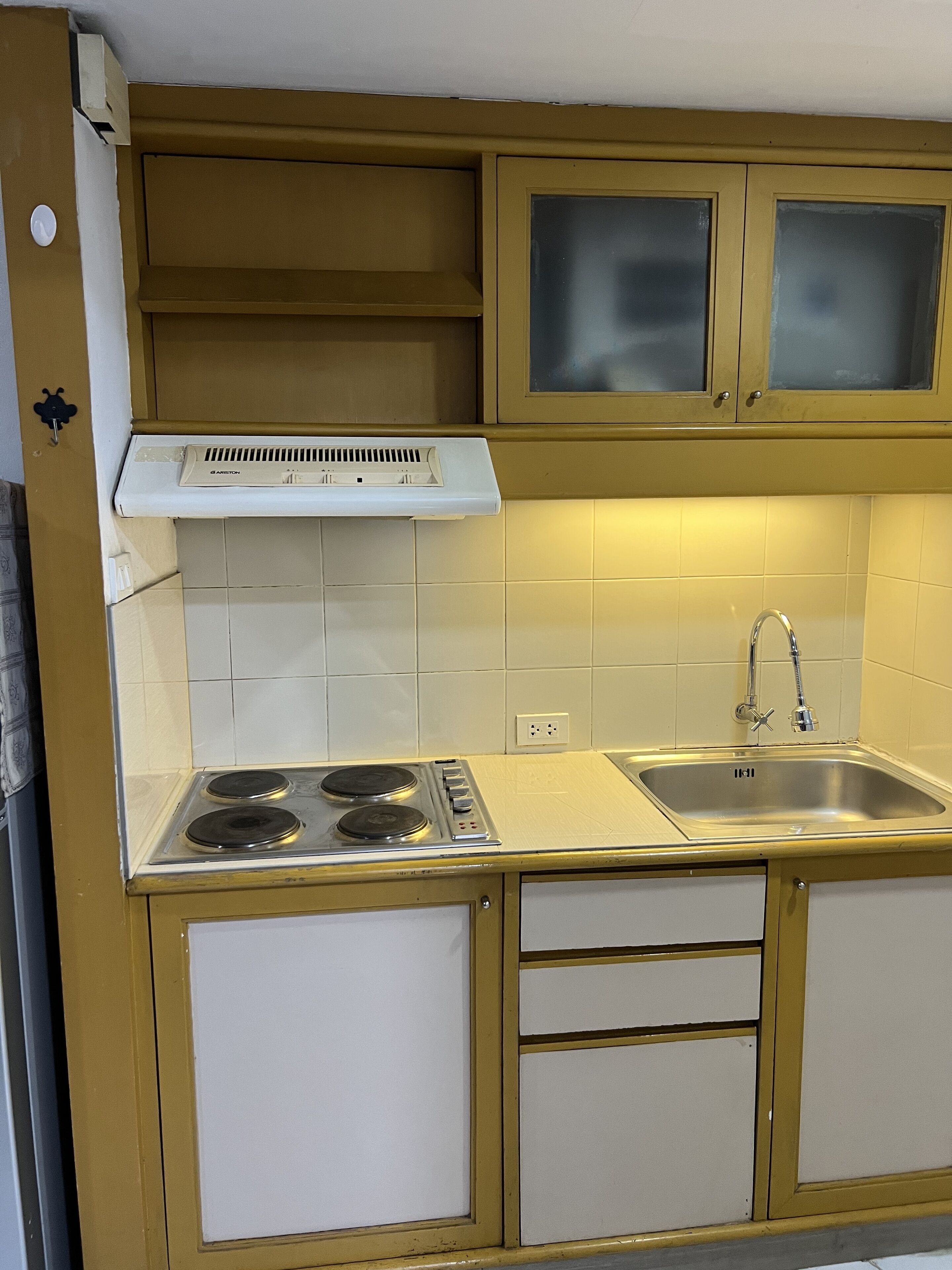 A kitchen with two gas stoves, a sink, and a range hood.
