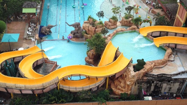 An indoor water park with multiple slides and pools. - Mall Suites Hotel (Bangkok)