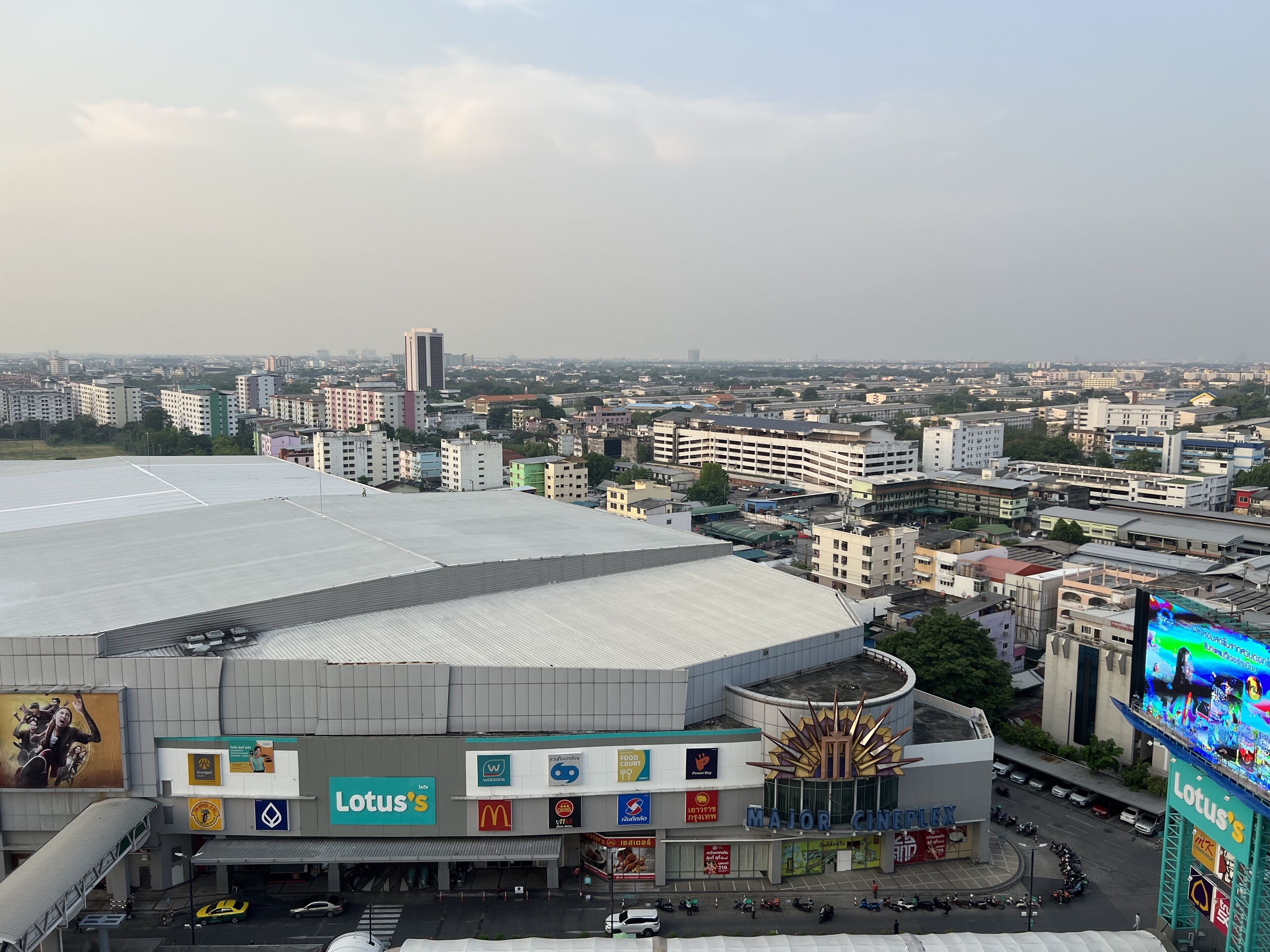 A multi-level commercial building with a prominent Lotus's sign, a cinema, and various commercial establishments.
