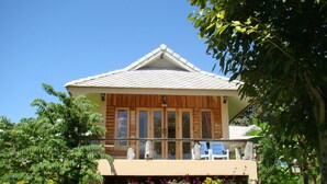A two-story building with a balcony, surrounded by lush greenery. - Pai Iyara Resort (Pai)
