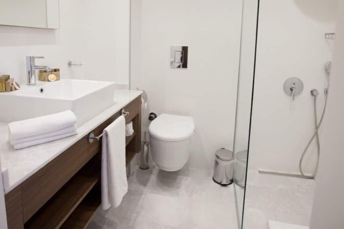Shower, designer toiletries, hair dryer, bathrobes