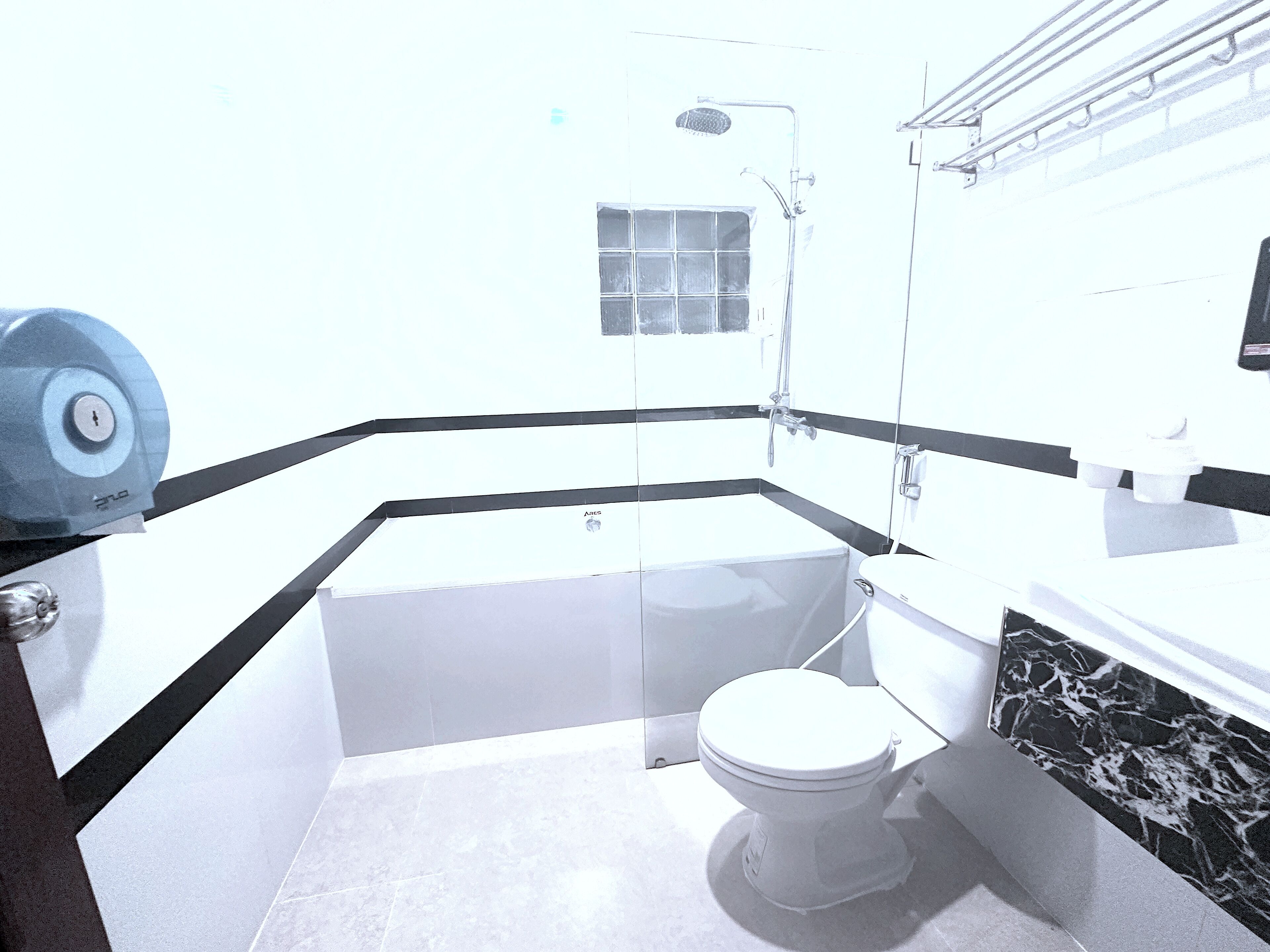 A bathroom with a bathtub, toilet, and shower.