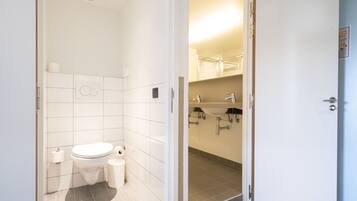A bathroom with a toilet, bidet, and sink.