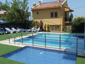 Seasonal outdoor pool, pool umbrellas, pool loungers