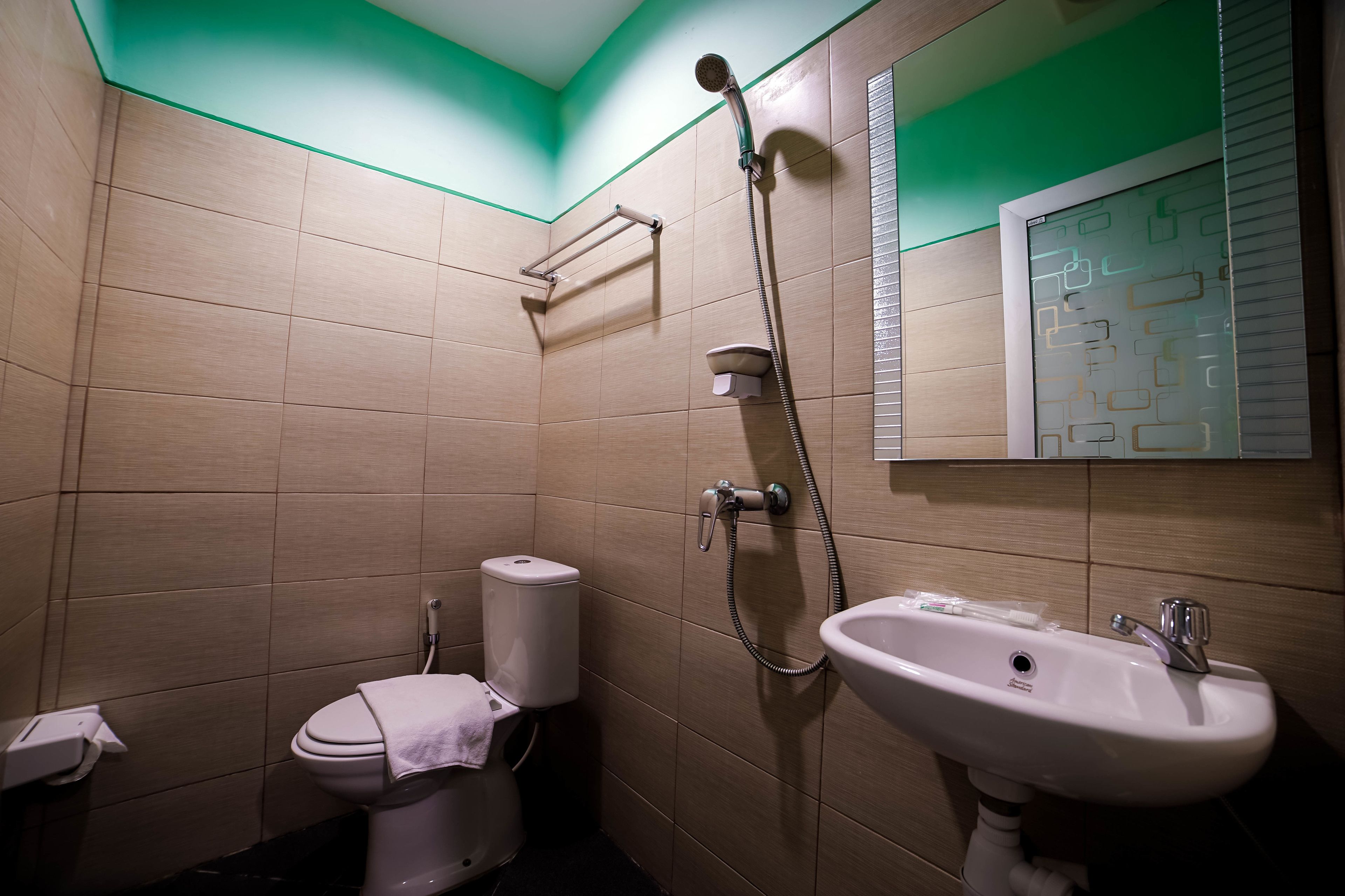 Un baño con inodoro, lavamanos y ducha.