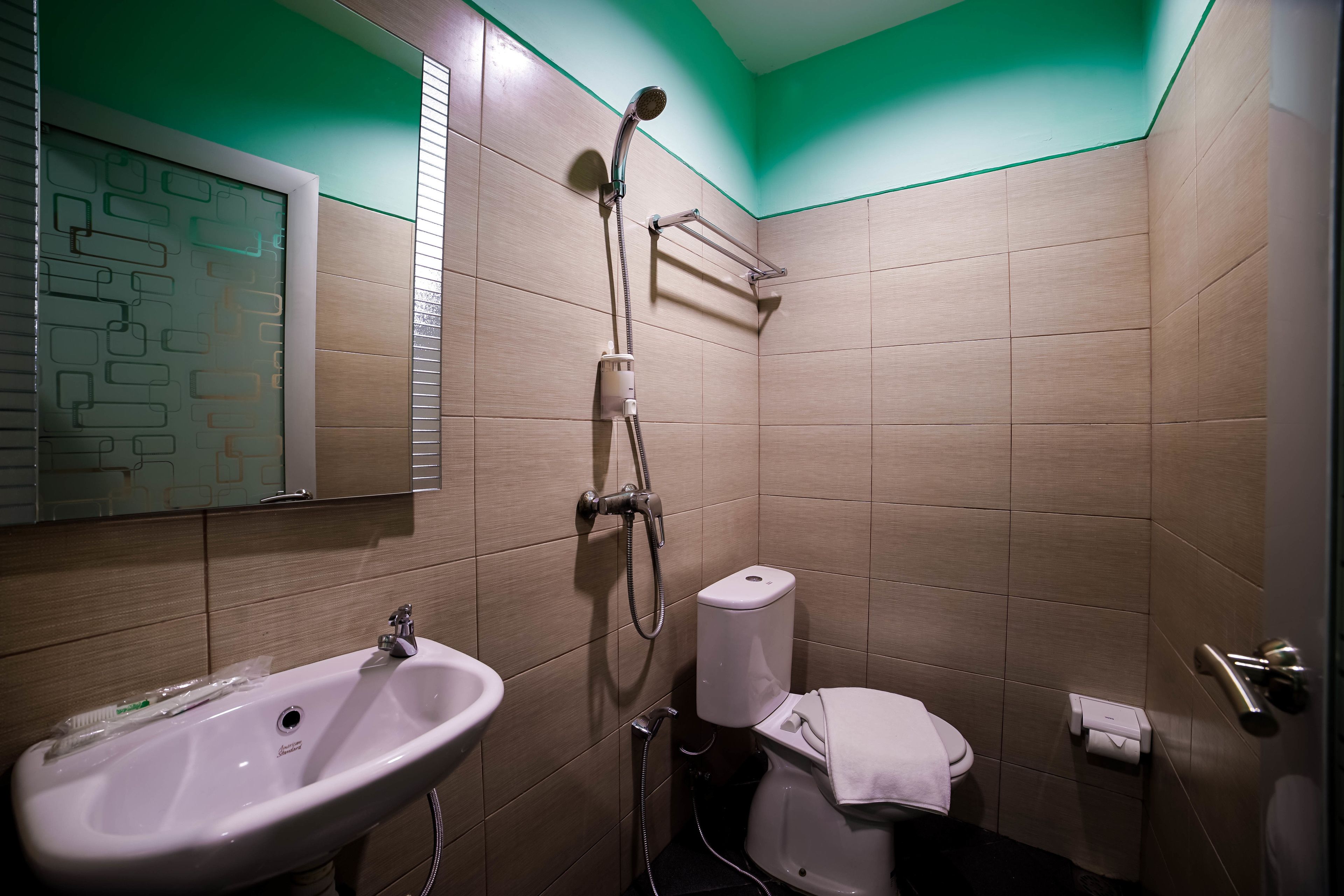 A bathroom with a sink, toilet, and shower.