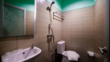A bathroom with a sink, toilet, and shower.