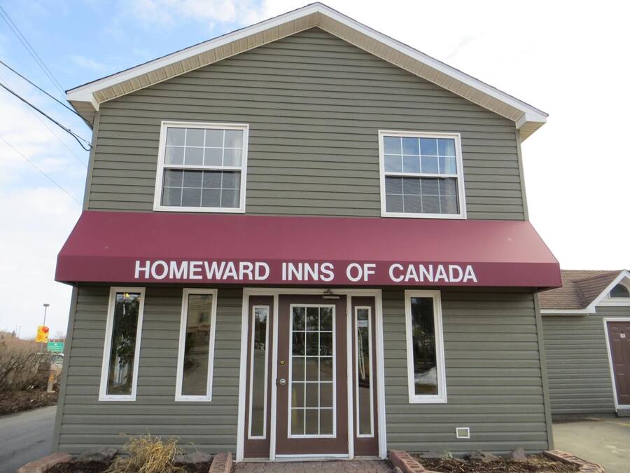 A two-story building with a maroon awning labeled "HOMEWARD INNS OF CANADA."