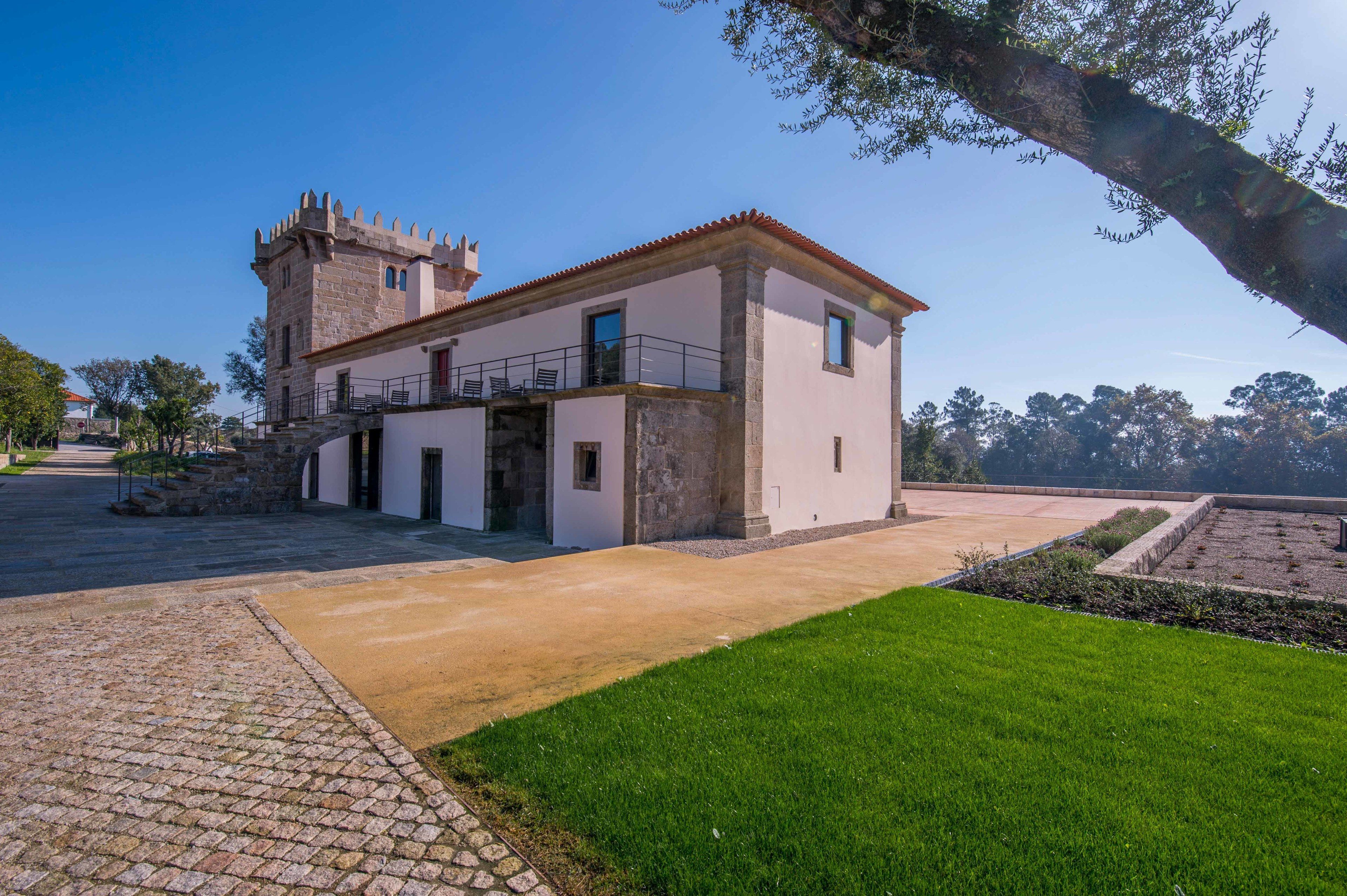 A historic building with a tower and a modern extension.