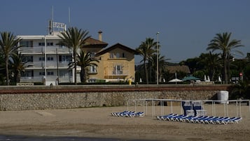 On the beach, sun loungers, beach umbrellas, beach towels