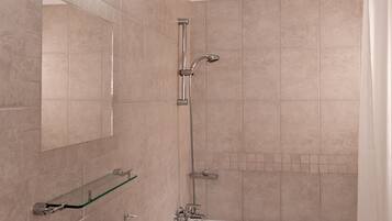 A bathroom with a white sink, mirror, and bathtub.