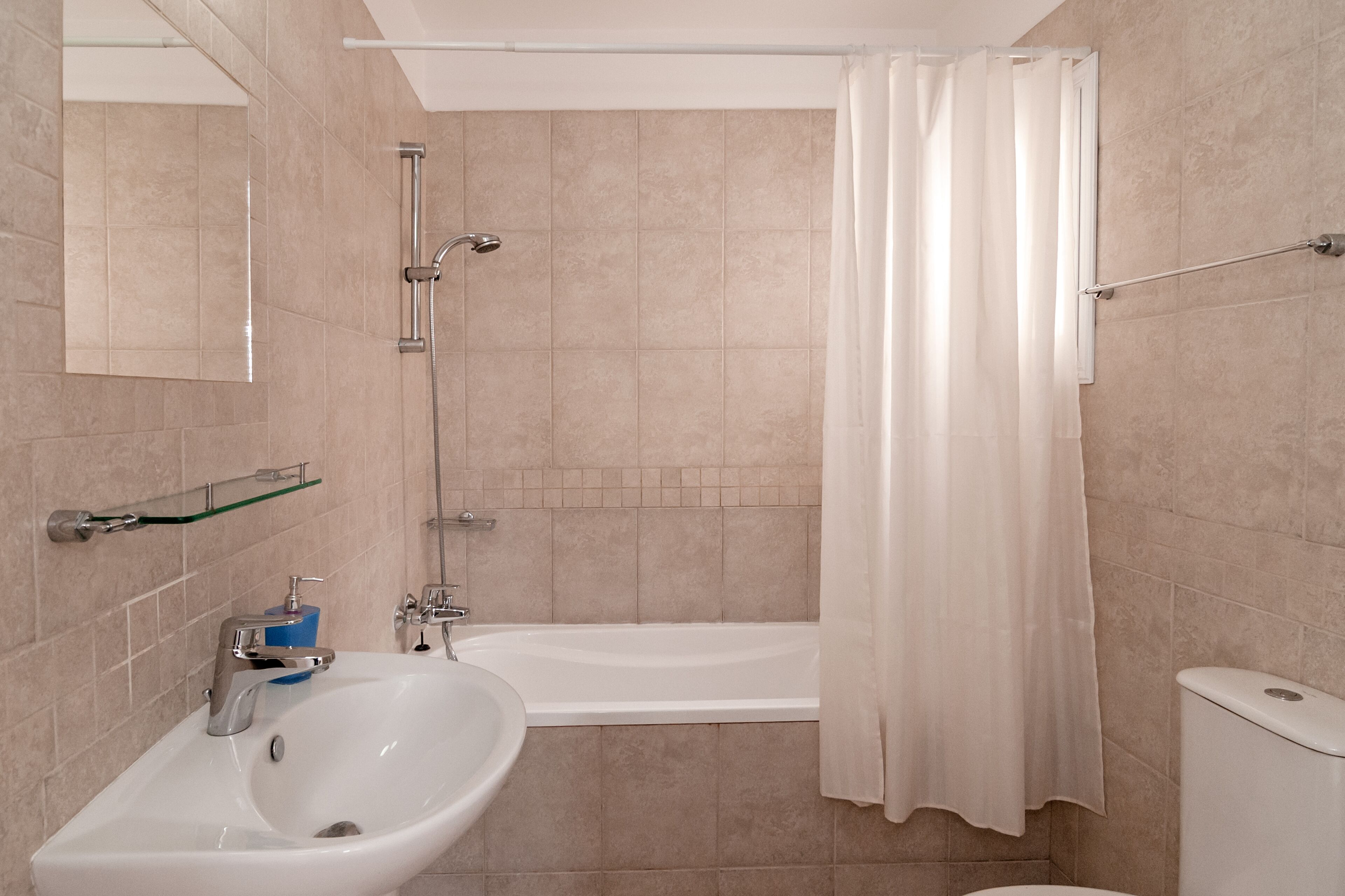 A bathroom with a bathtub, a sink, and a toilet.