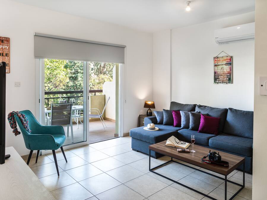 A modern living room with a sofa, a coffee table, and a TV.