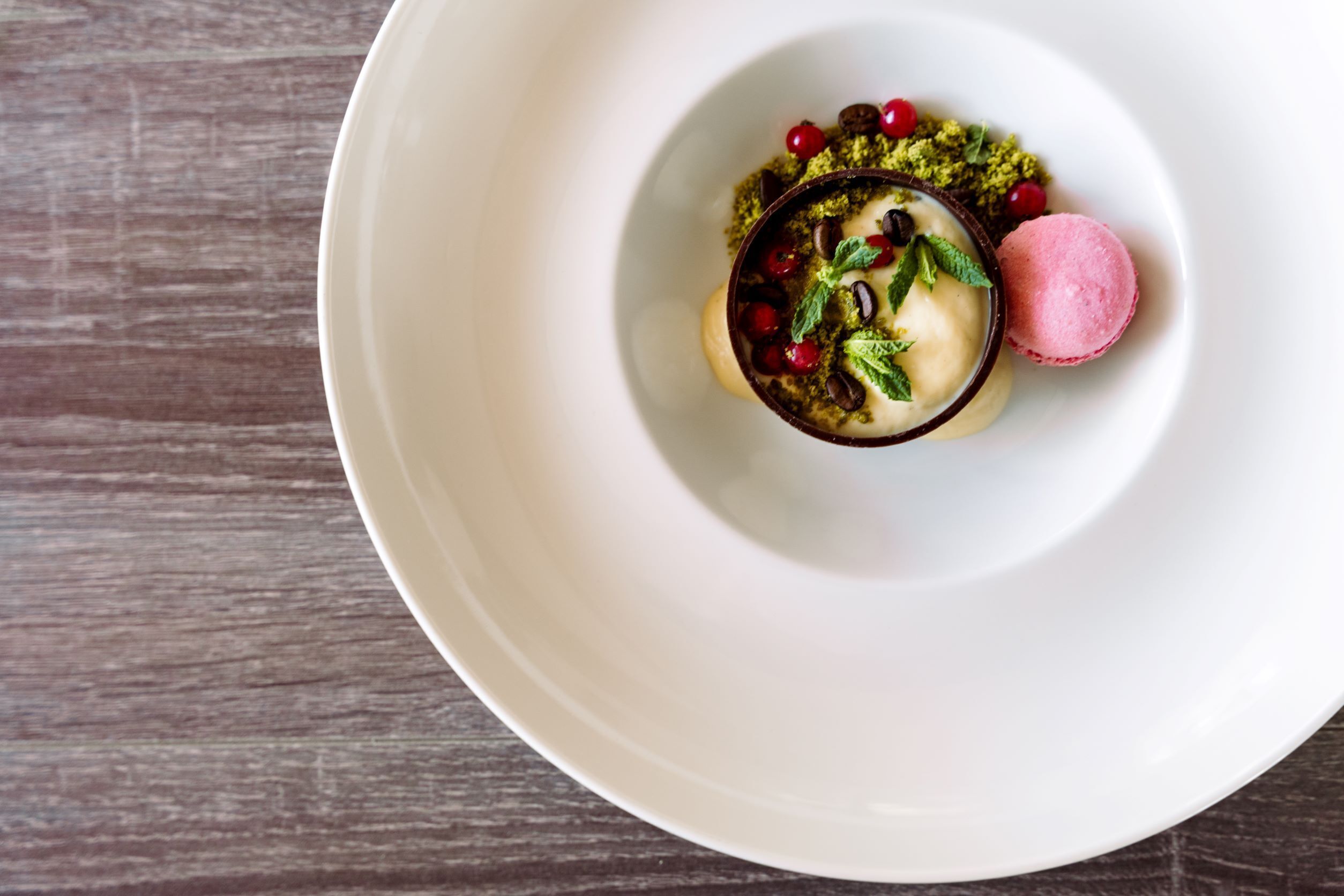 A dessert on a white plate with a wooden background.