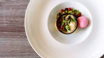 A dessert on a white plate with a wooden background.