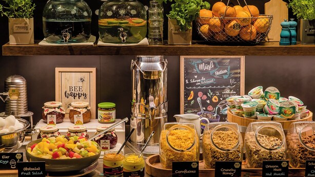 A buffet with various food items and condiments. - Motel One München-Olympia Gate (Munich)