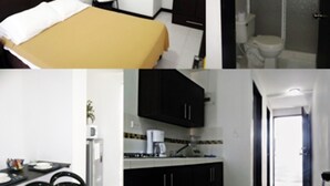 A hotel room with a bed, a chair, a wardrobe, a shower, a sink, and a small kitchen area. - Apartasuites San Marcos (Cali)