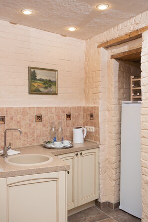 Enjoy cooking in this kitchen with a sink, countertop, and refrigerator.