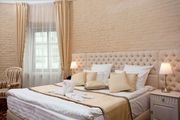 Relax in comfort with a neatly made bed and plush armchair, set against a classic brick backdrop.