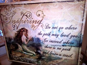 A decorative sign with a mermaid and inspirational text. - LeMarida Suites (Speightstown)