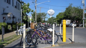 A bicycle parking area with a sign indicating payment for parking. - Crosswinds Rehoboth  (Rehoboth Beach)