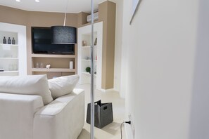 Apartment, 1 Bedroom | Living area | 55-inch flat-screen TV with digital channels, TV