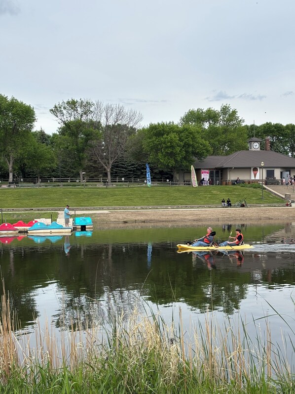 A tranquil lakeside scene with a small building labeled "Hotel." - Dakota Inn (Huron)