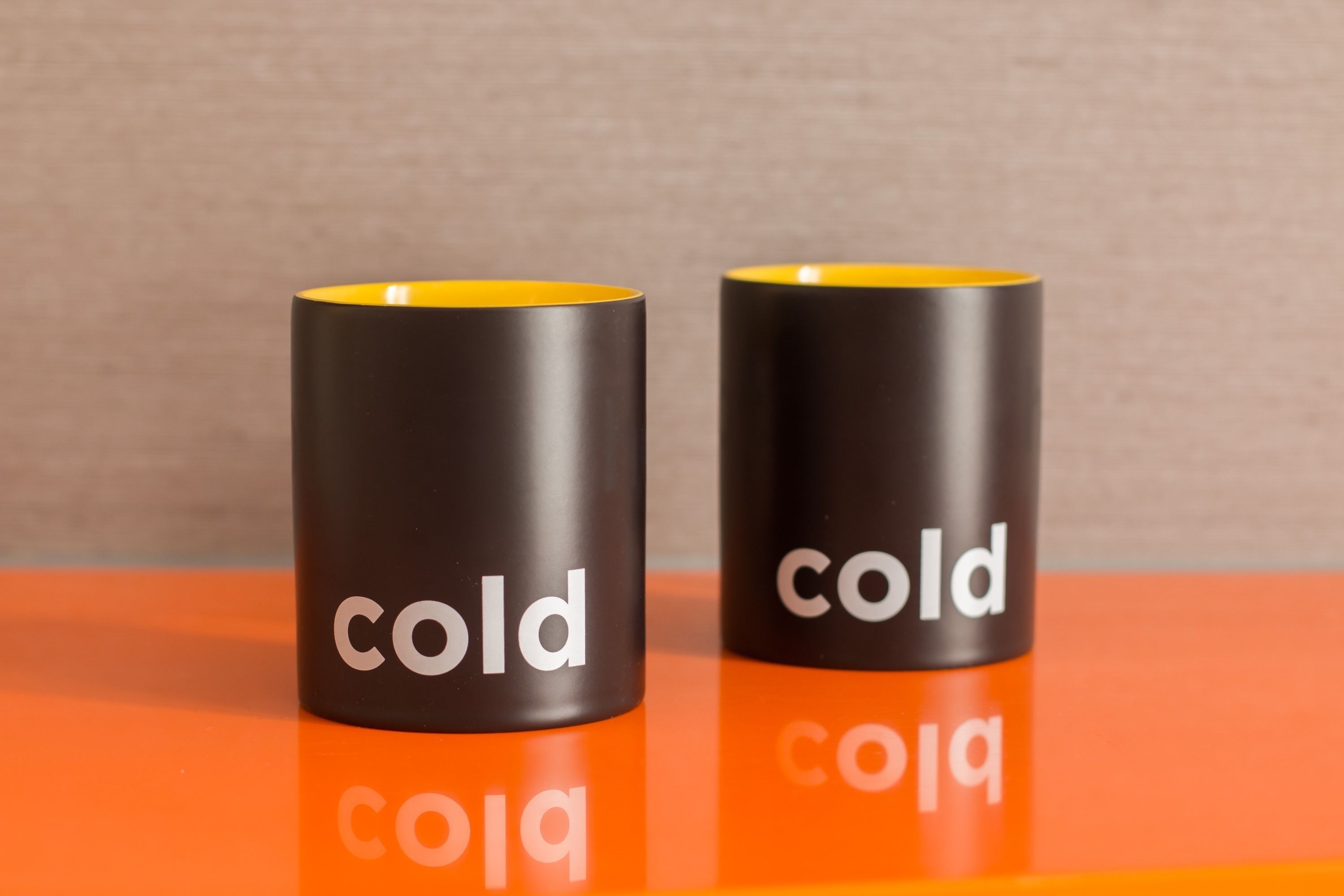 Two black and yellow containers with the word "cold" on them.