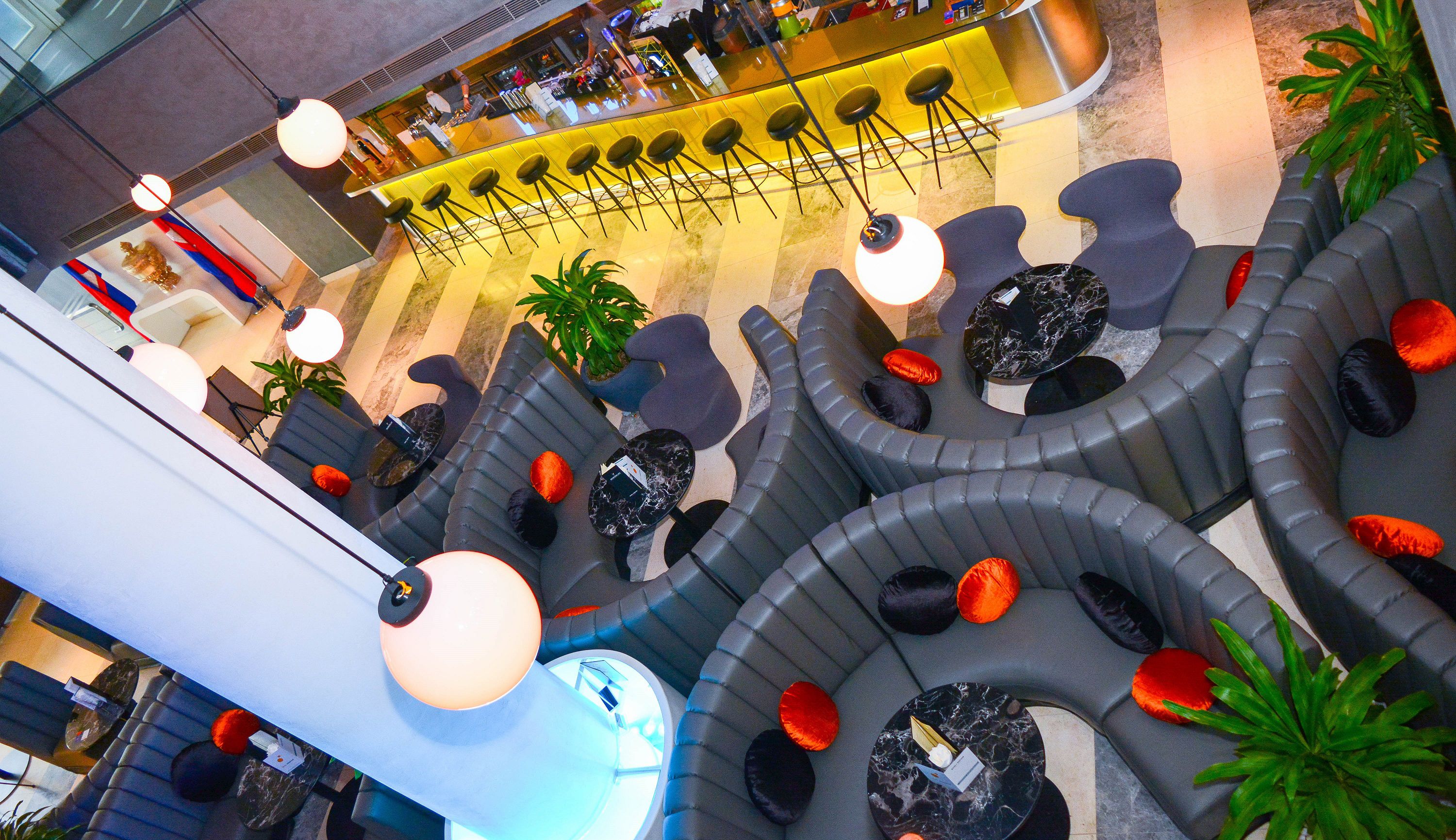 A modern bar area with a curved seating arrangement and a bar counter.